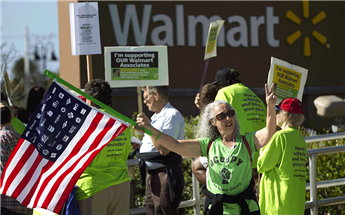 Wal-Mart employees and union supporters rally for better pay and benefits outside a store in Boynton Beach, Fla., on Nov 23, 2012. AP